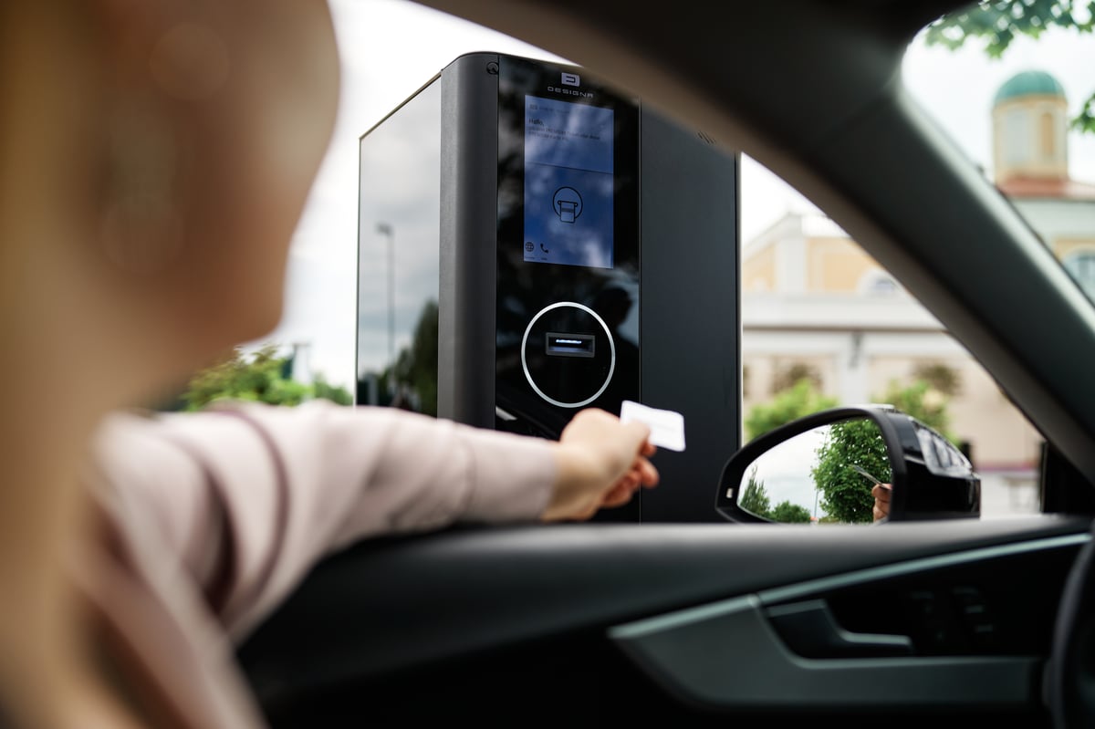 Parking garage entry gate with driver taking a ticket
