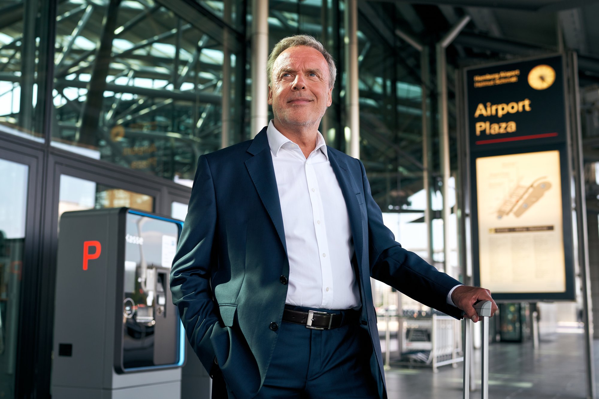 Business traveler with luggage at airport parking area
